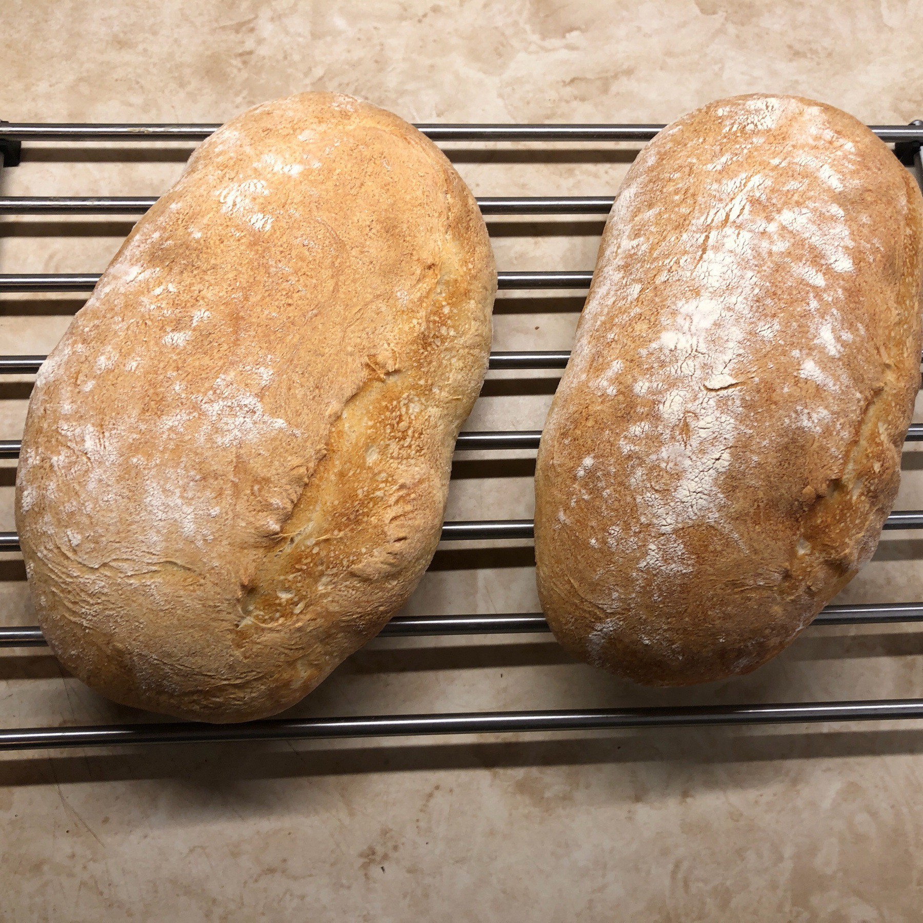 Loaves of bread on a cooling rack.