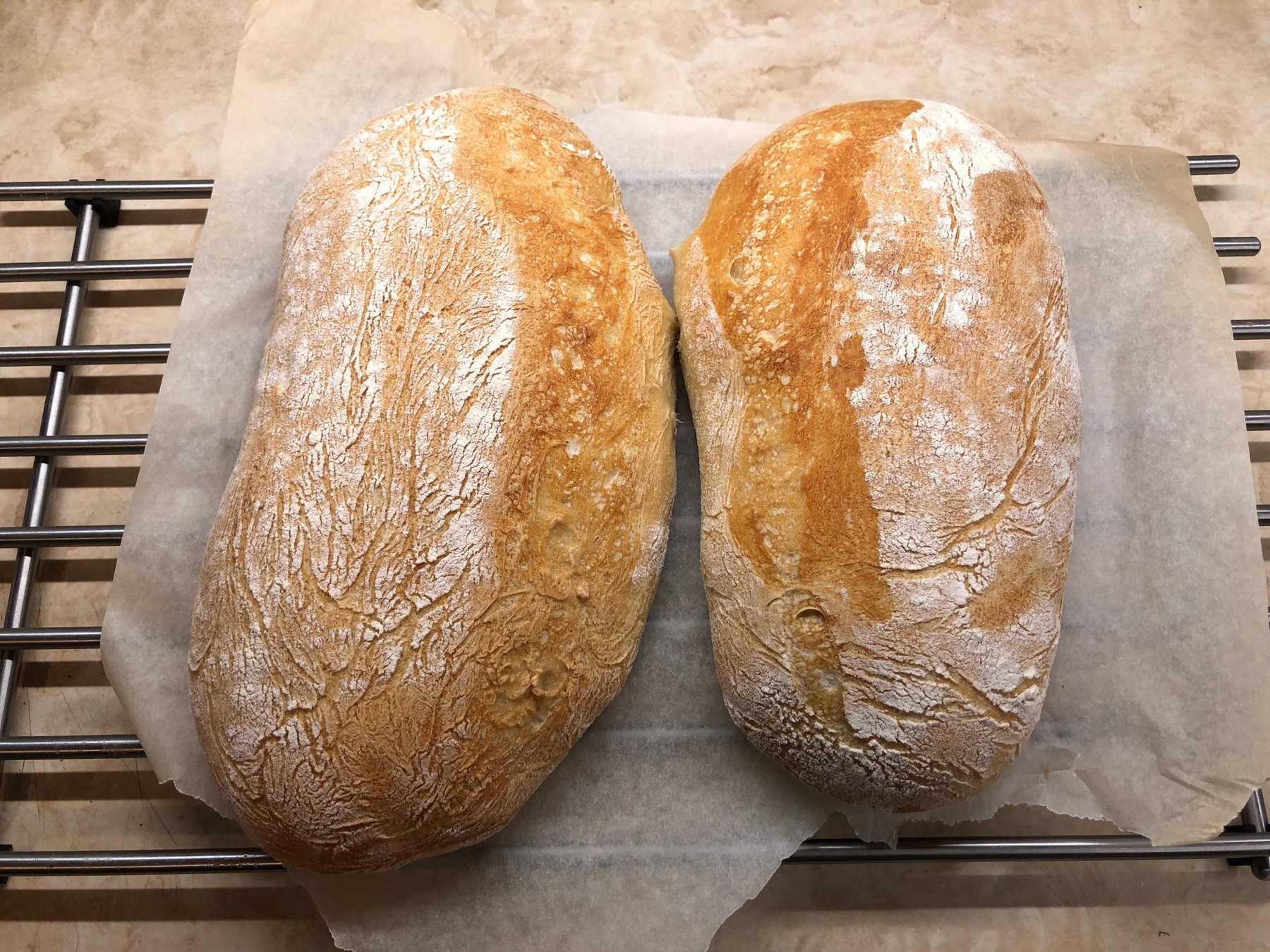 Two loaves of bread cooling.