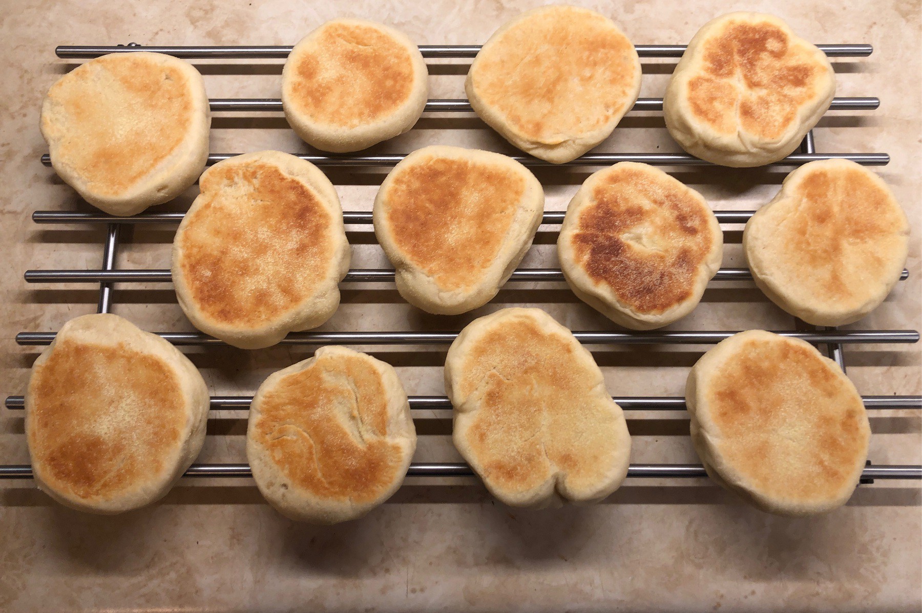 English muffins cooling on rack.