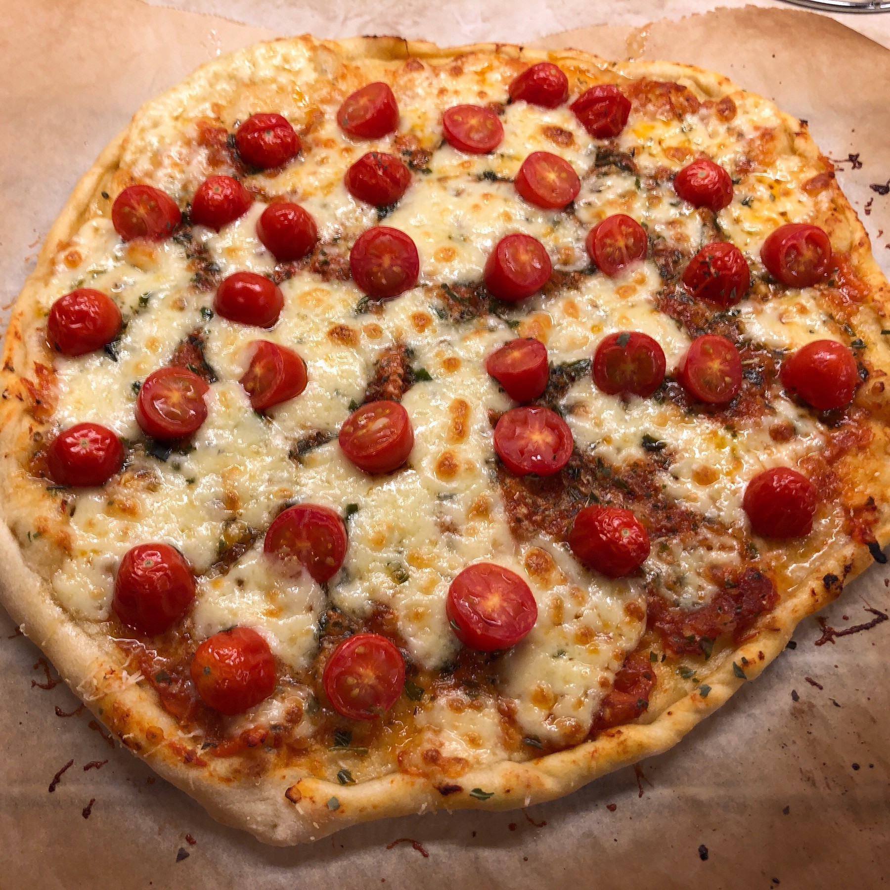 Pizza with small tomatoes on it