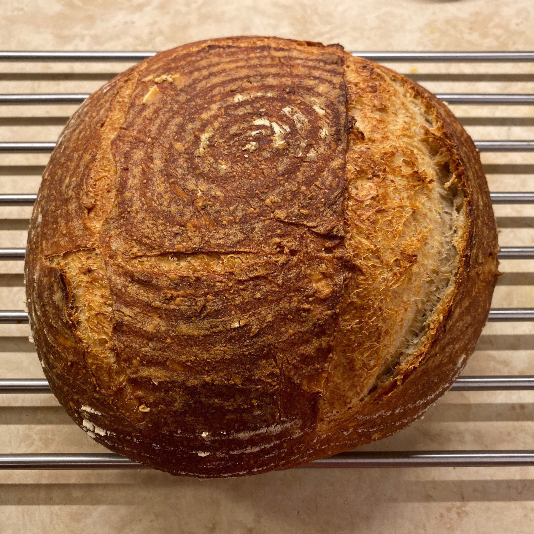 Round loaf of sourdough bread cooling.