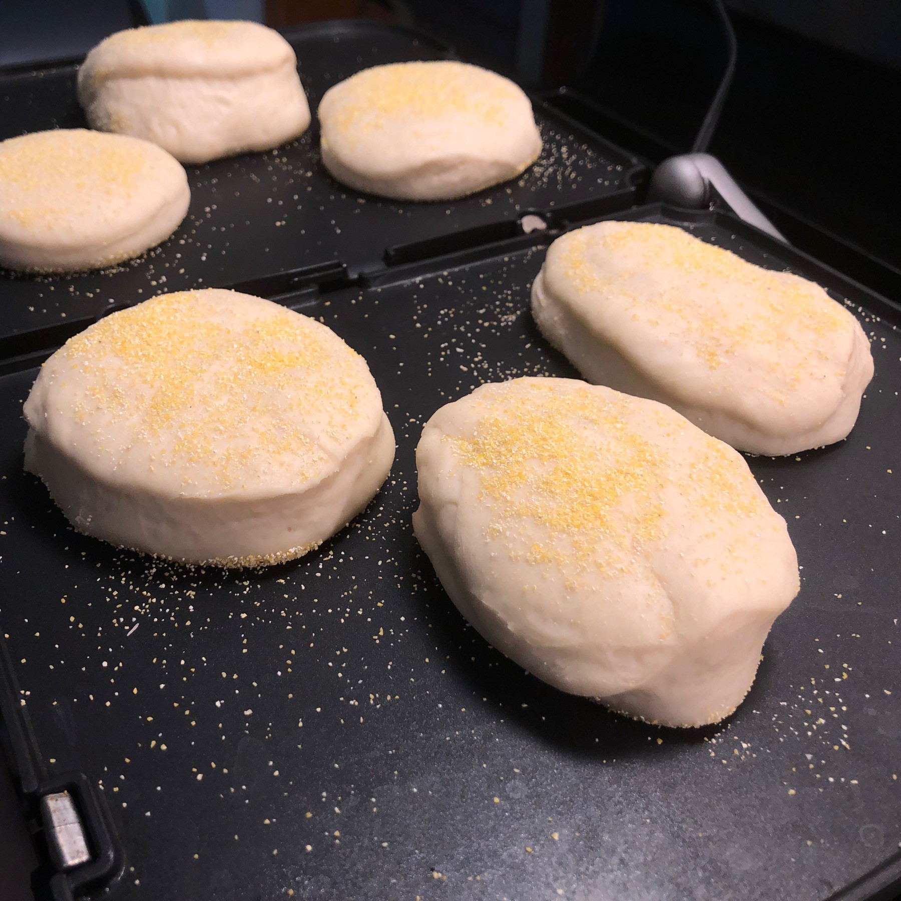English muffins cooking on grill.