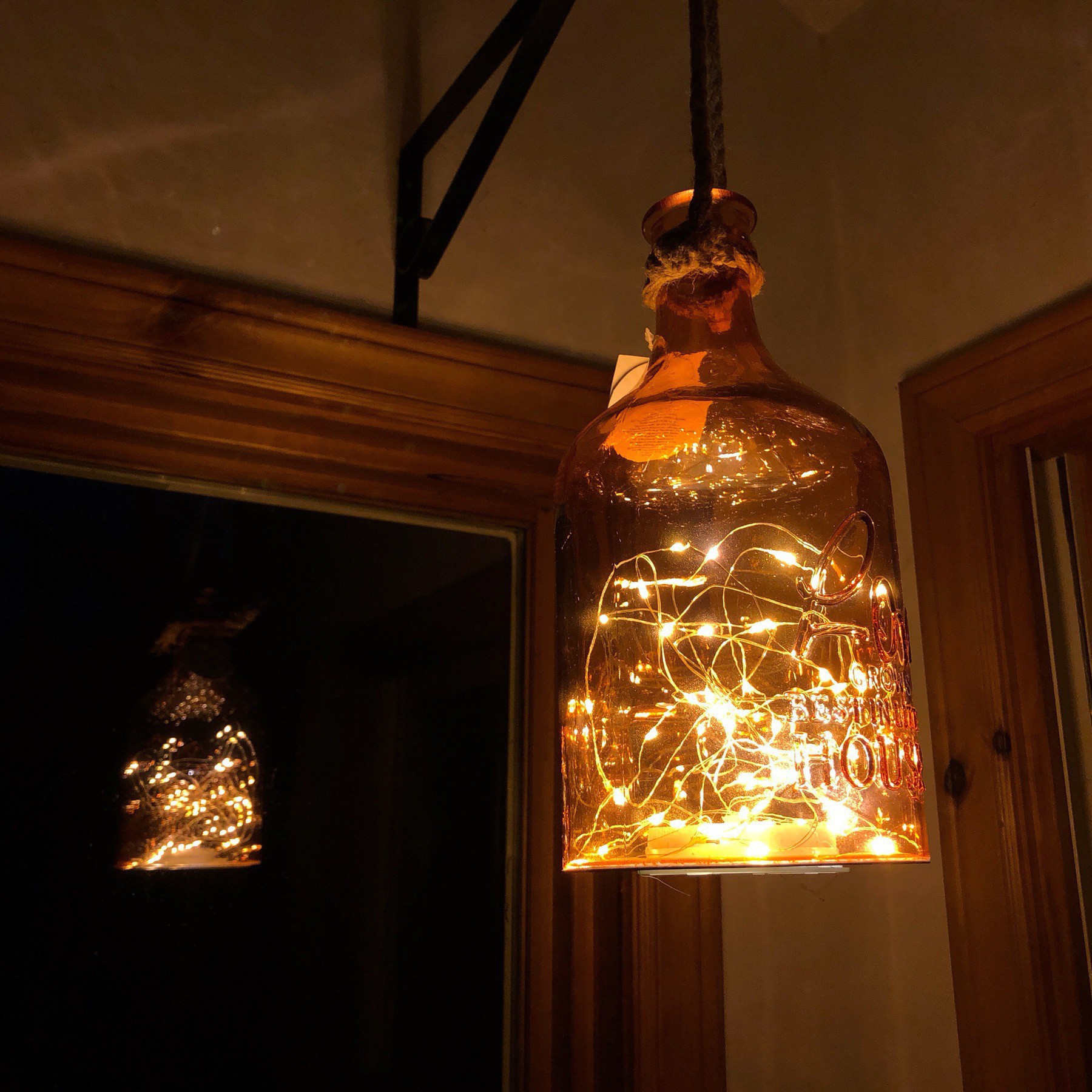 LED ights in bottle hanging from hook.