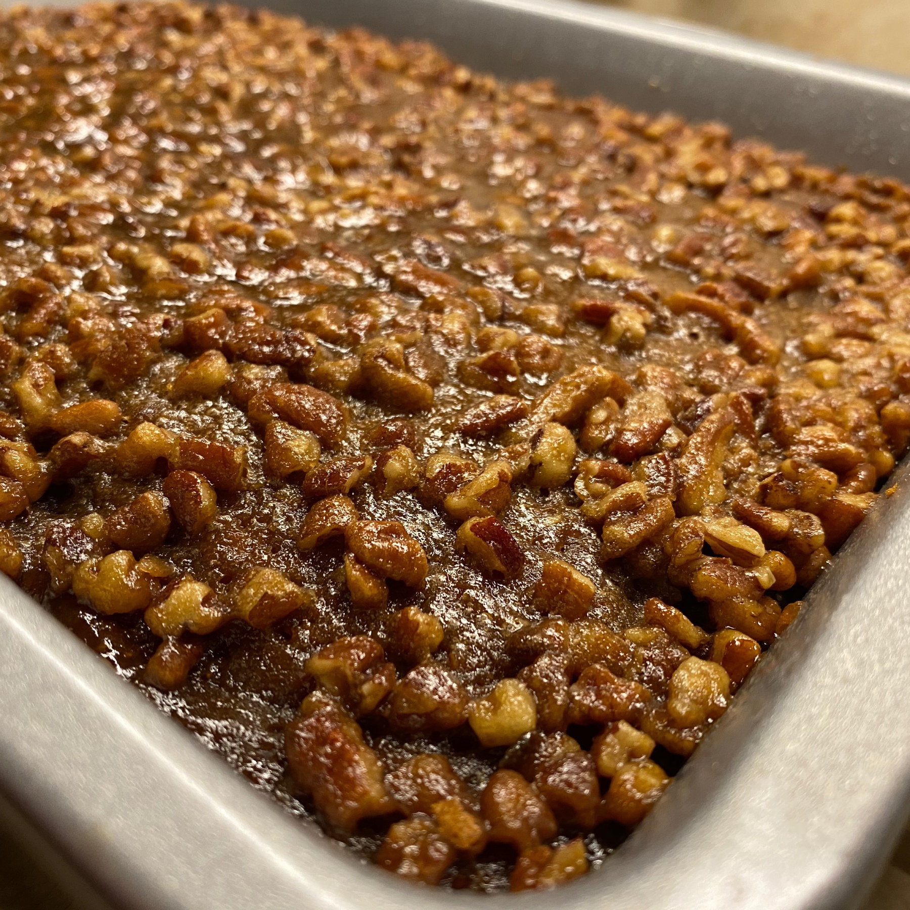 Pecans in glaze on top of cake.