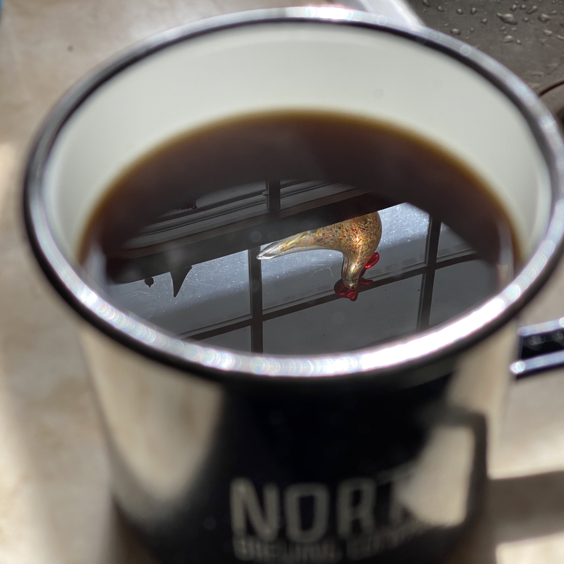 Reflection in coffee mug.