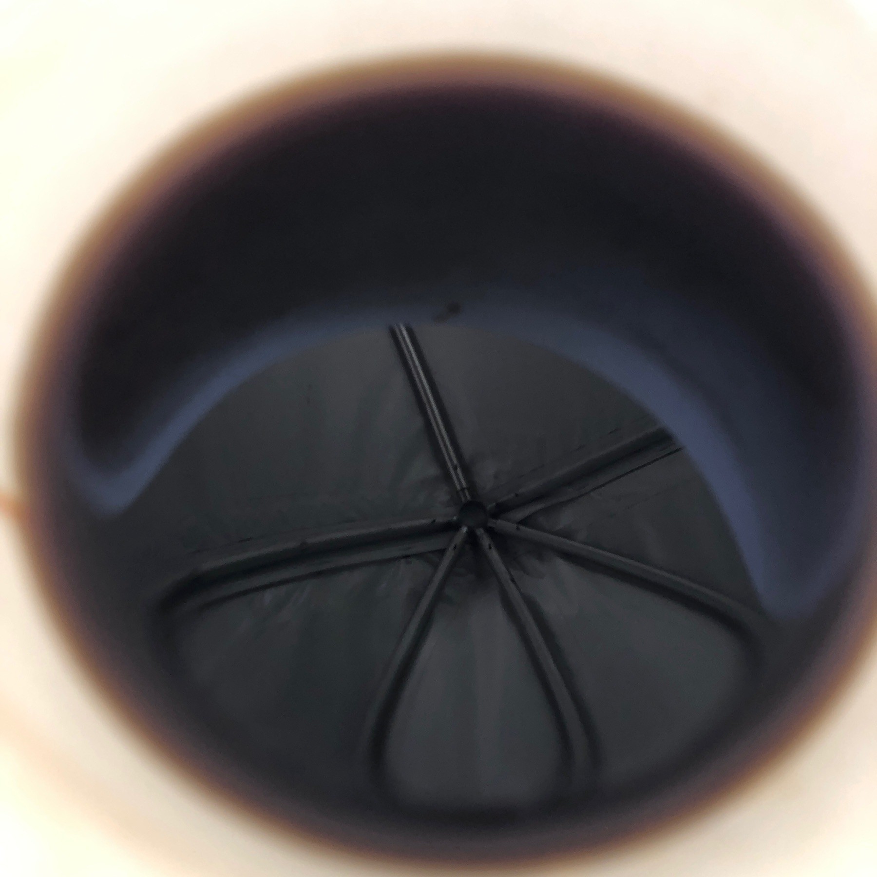 Inside of tent reflected in coffee in cup.