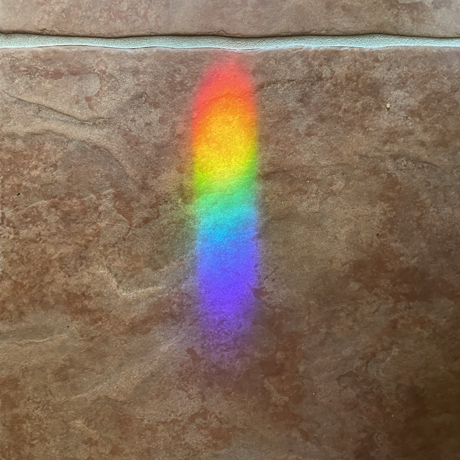 Rainbow on floor tile.