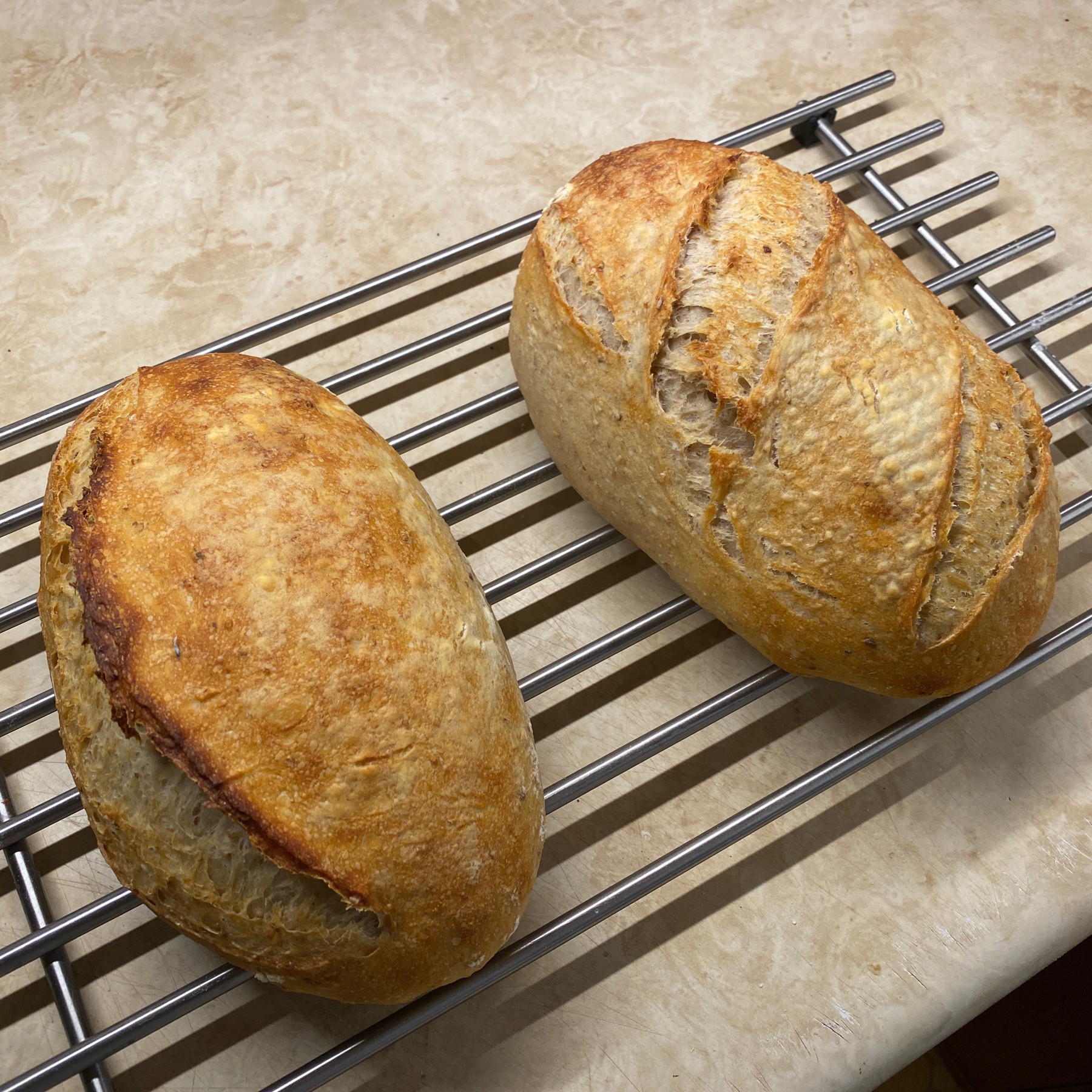 Sourdough bread cooling on rack.