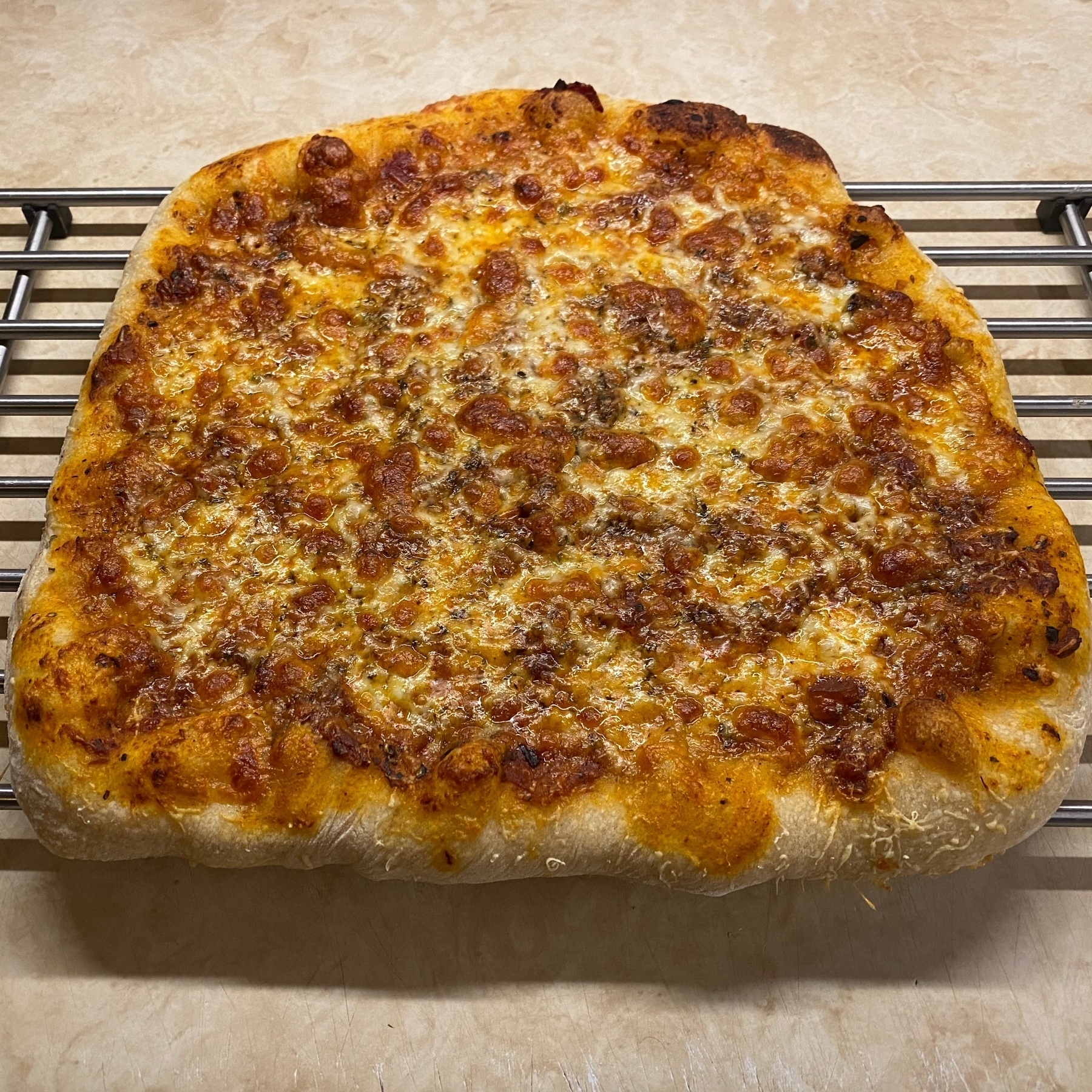 Pizza cooling on rack.