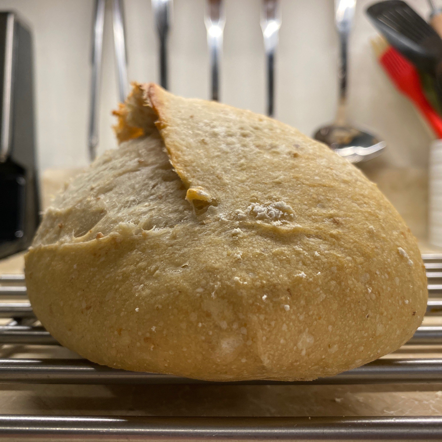 Sourdough bread on metal rack.